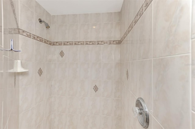 bathroom with tiled shower