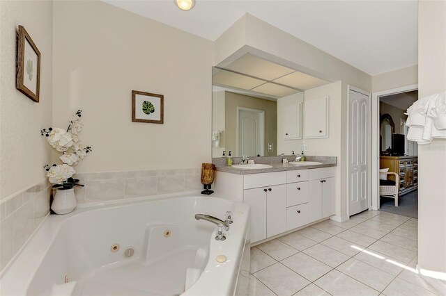 bathroom featuring vanity, a tub to relax in, and tile patterned floors