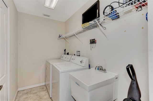 washroom with sink and independent washer and dryer