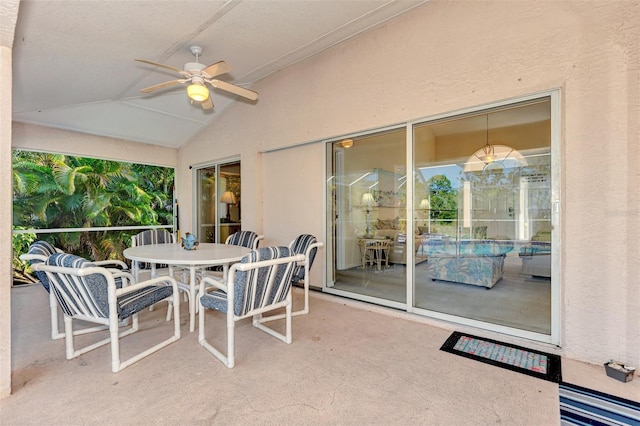 sunroom with ceiling fan, a healthy amount of sunlight, and lofted ceiling