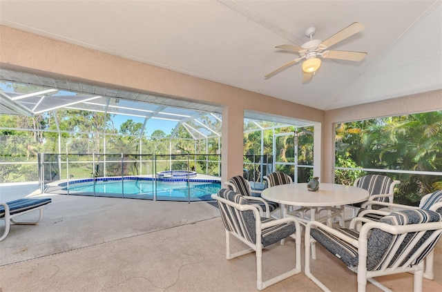 exterior space with ceiling fan, a swimming pool, and vaulted ceiling