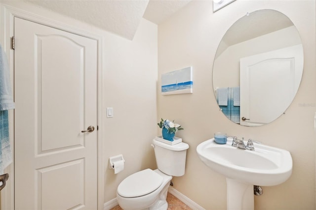 bathroom featuring toilet and sink