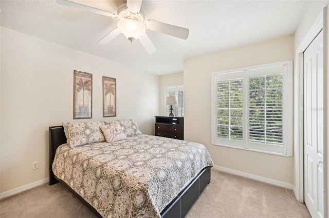 bedroom featuring light colored carpet and ceiling fan