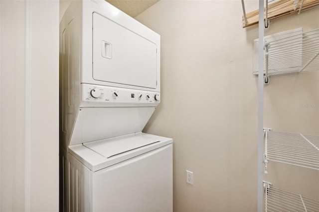 laundry area with stacked washer and dryer