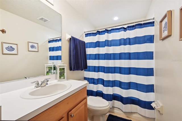 bathroom with vanity, a shower with curtain, a textured ceiling, and toilet