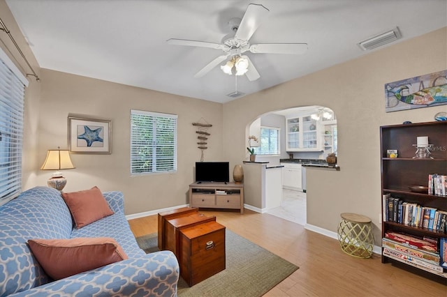 living room featuring ceiling fan and light hardwood / wood-style flooring