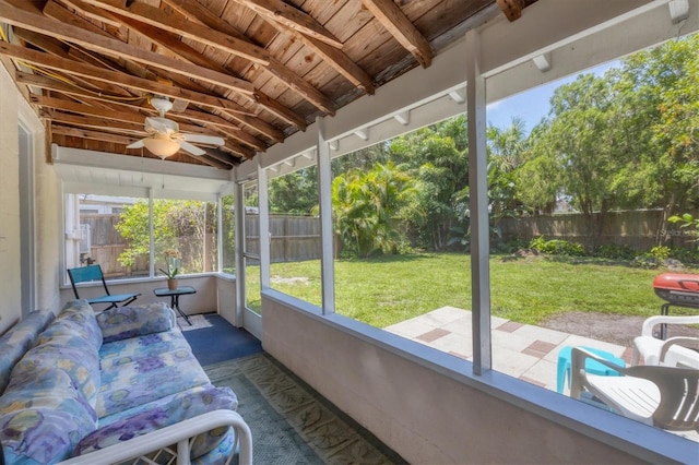 sunroom / solarium featuring vaulted ceiling with beams, ceiling fan, and wooden ceiling