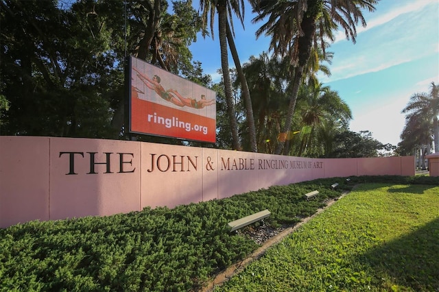 community / neighborhood sign with a lawn