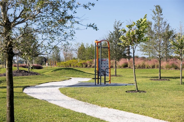 view of property's community featuring a yard and a playground