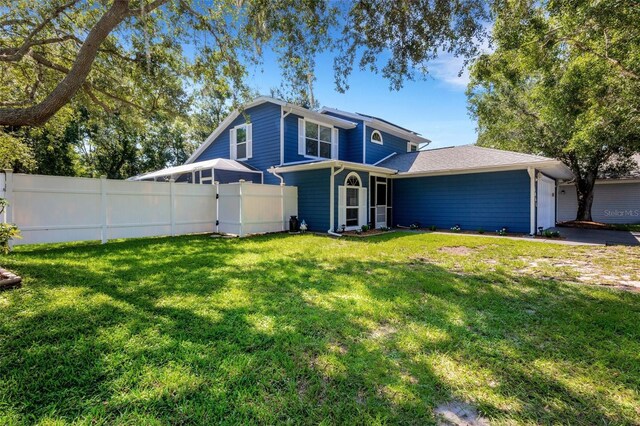 view of front of house featuring a garage and a front yard