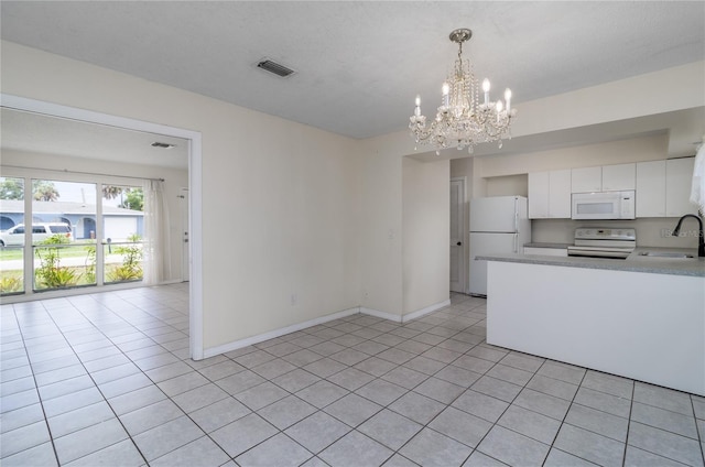 kitchen featuring sink, hanging light fixtures, light tile patterned floors, white appliances, and white cabinets