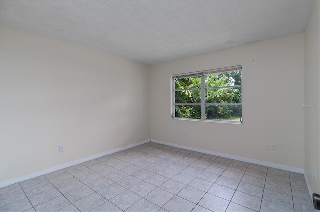 unfurnished room with a textured ceiling