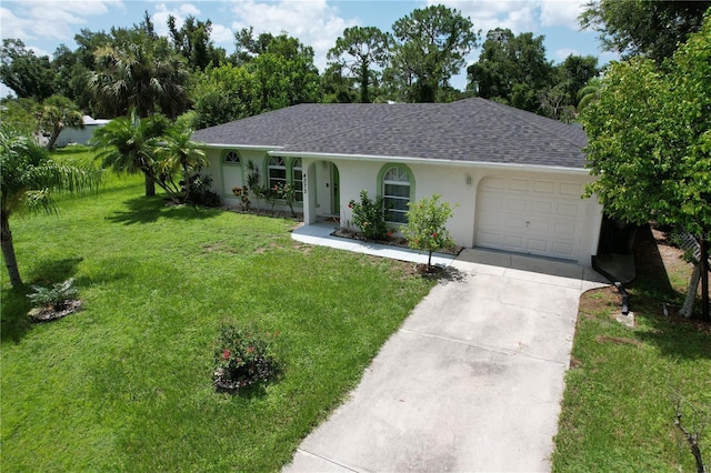 single story home featuring a garage and a front lawn