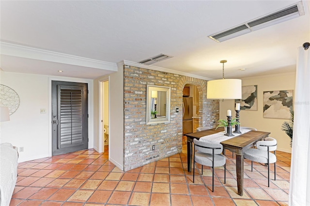 dining area with light tile patterned floors, ornamental molding, arched walkways, and visible vents