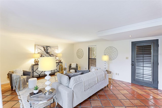 living area with ornamental molding, baseboards, and tile patterned floors