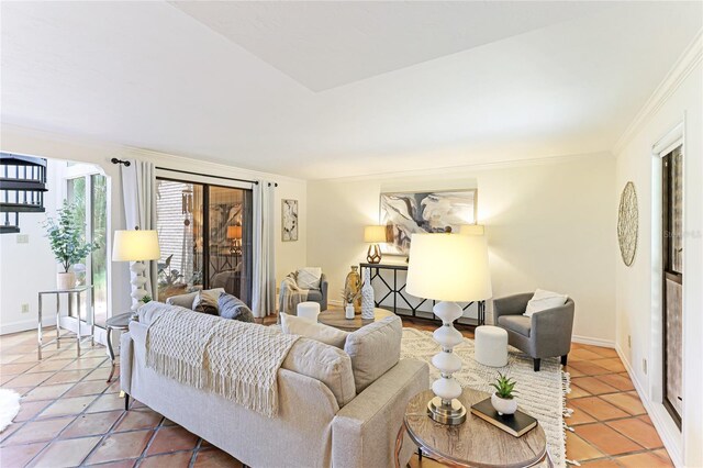 living room with ornamental molding, baseboards, and light tile patterned floors