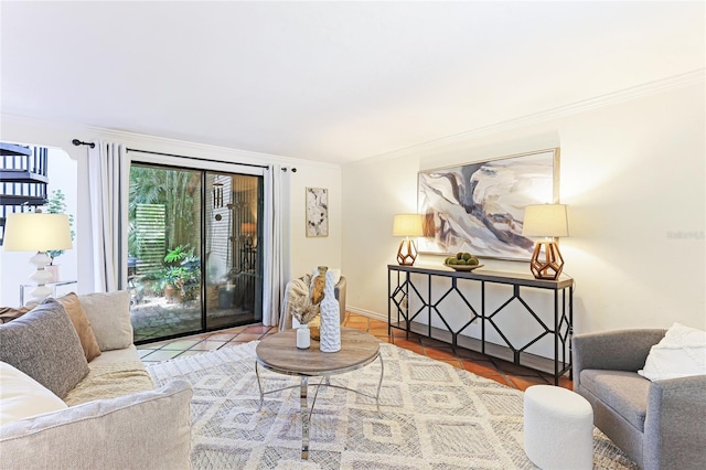 living area featuring baseboards and crown molding