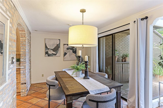 dining room with light tile patterned floors, baseboards, and crown molding