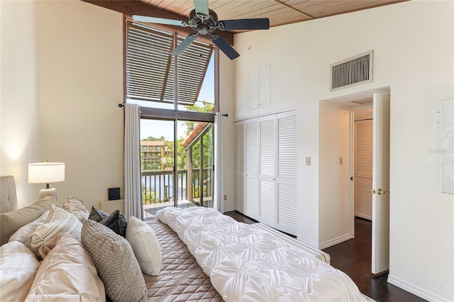 bedroom with high vaulted ceiling, visible vents, baseboards, access to exterior, and dark wood-style floors