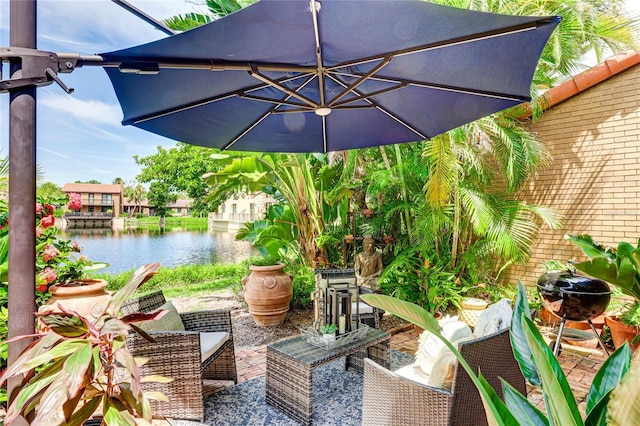 view of patio with a water view