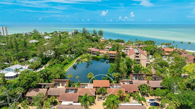 birds eye view of property with a water view and a residential view