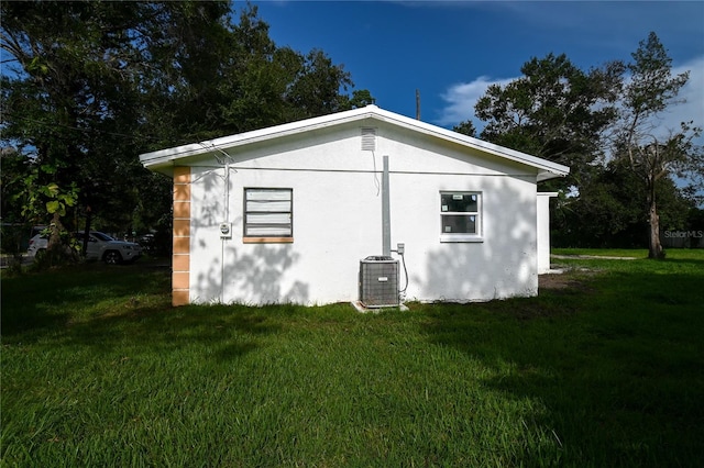 view of property exterior featuring a yard and central AC