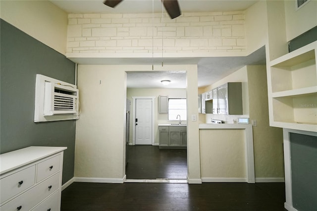 interior space featuring sink, an AC wall unit, ceiling fan, and dark wood-type flooring