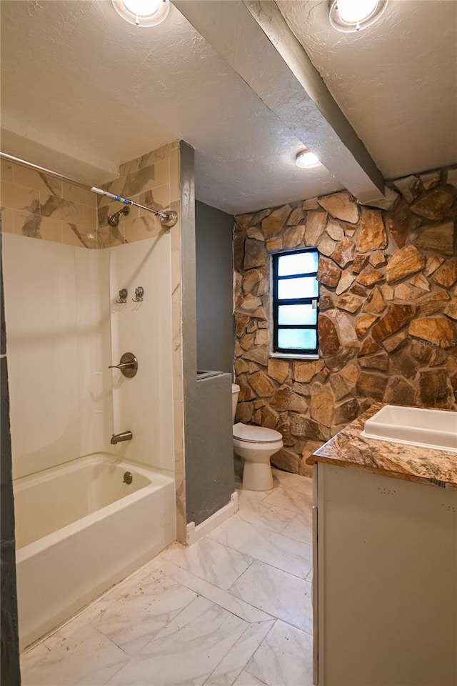 full bathroom featuring vanity, shower / bath combination, toilet, a textured ceiling, and tile patterned flooring