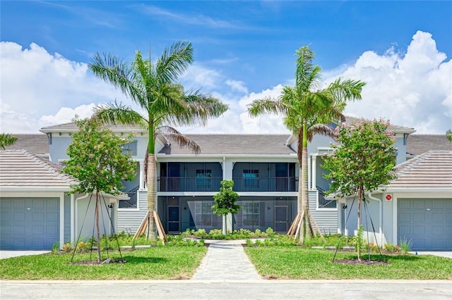 view of front of home with a garage and a front lawn