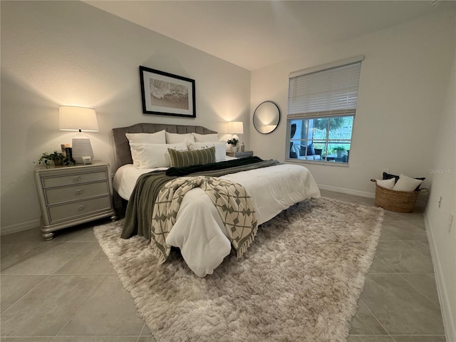 17445 Opal Sand Dr Unit 104, Venice, FL 34293 - bedroom with light tile patterned flooring and baseboards
