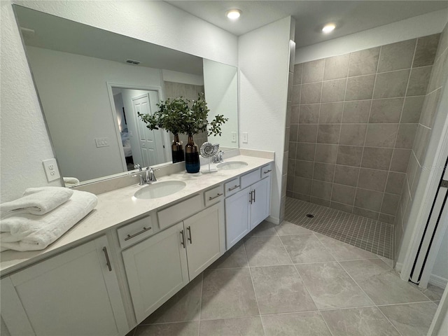 17445 Opal Sand Dr Unit 104, Venice, FL 34293 - ensuite bathroom with double vanity, walk in shower, tile patterned floors, and recessed lighting