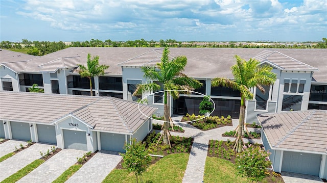 17445 Opal Sand Dr Unit 104, Venice, FL 34293 - townhome / multi-family property with a tiled roof and community garages
