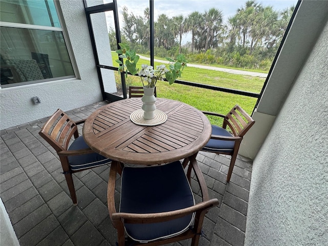 17445 Opal Sand Dr Unit 104, Venice, FL 34293 - sunroom featuring outdoor dining space
