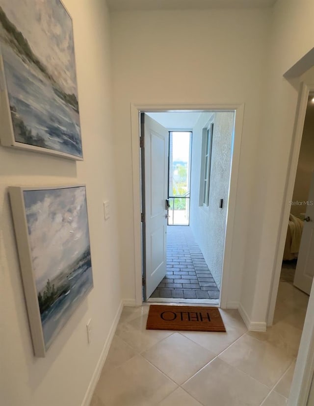 17445 Opal Sand Dr Unit 104, Venice, FL 34293 - hall featuring light tile patterned flooring and baseboards