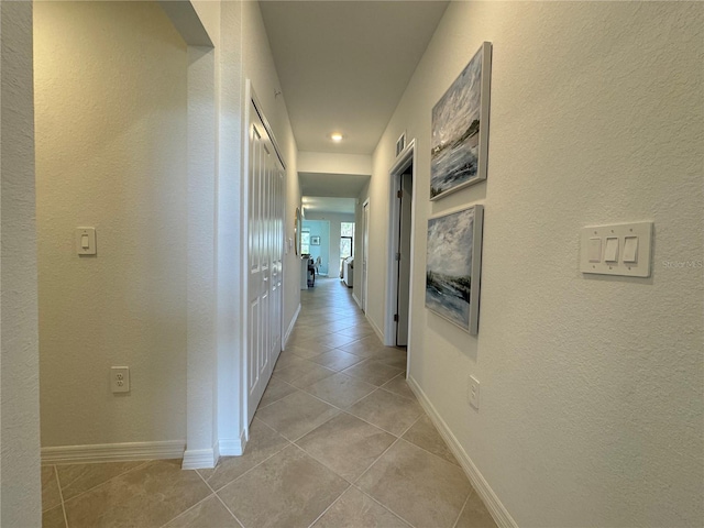 17445 Opal Sand Dr Unit 104, Venice, FL 34293 - hall with light tile patterned floors, baseboards, and recessed lighting