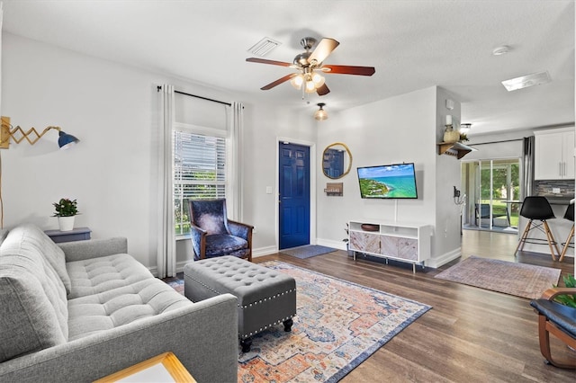 living room featuring hardwood / wood-style floors and ceiling fan