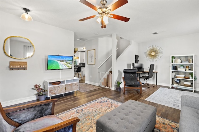 living room with ceiling fan and dark hardwood / wood-style floors