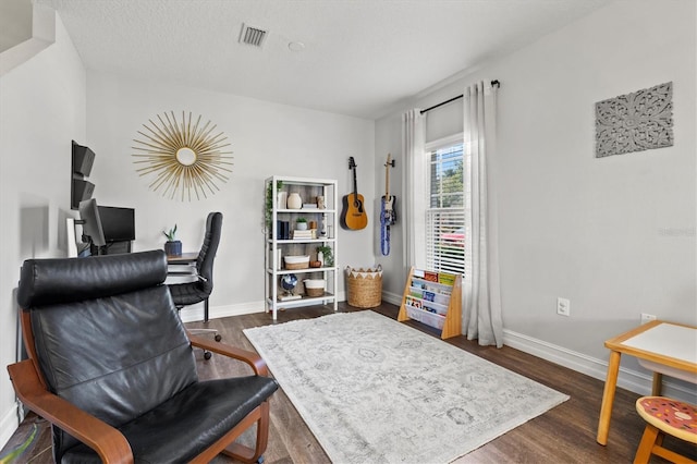 office with dark hardwood / wood-style floors and a textured ceiling