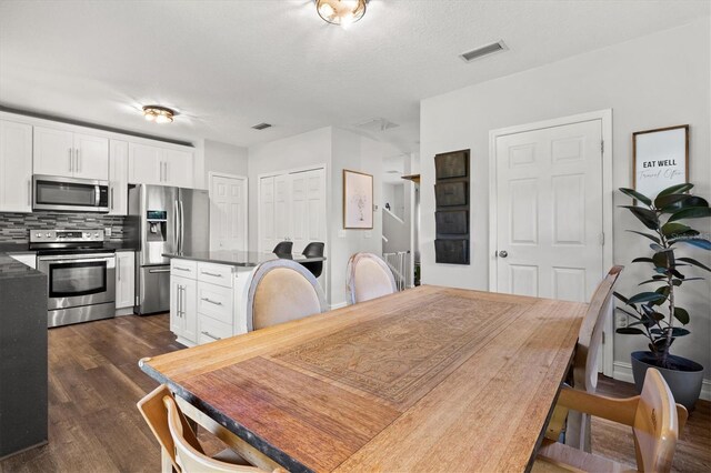 dining space featuring dark hardwood / wood-style floors