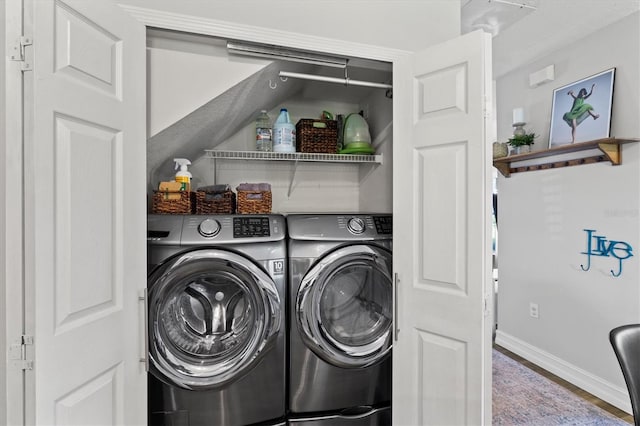 laundry room featuring washer and clothes dryer and hardwood / wood-style floors