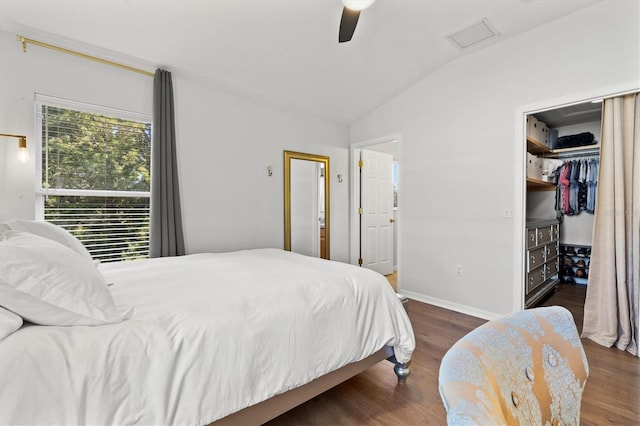 bedroom featuring ceiling fan, dark hardwood / wood-style floors, lofted ceiling, and a closet