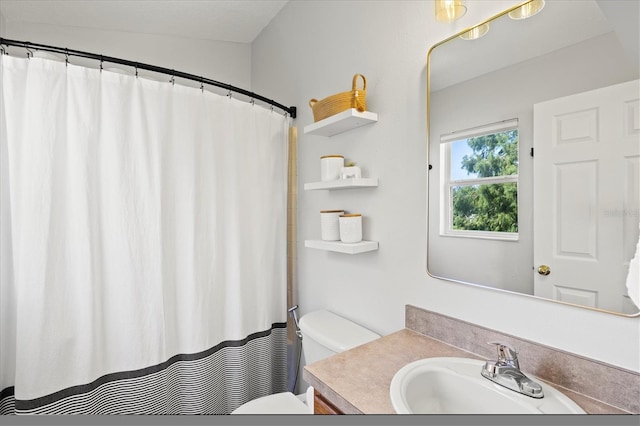 bathroom featuring vanity and toilet