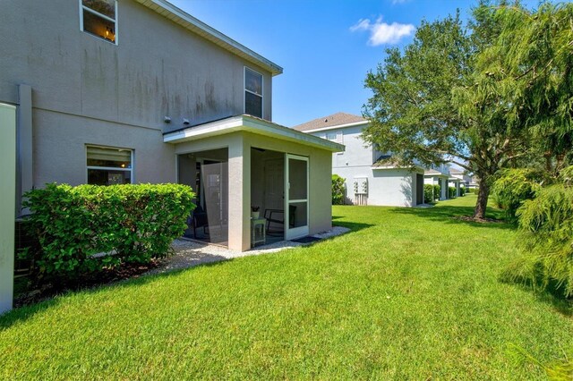 view of yard with a sunroom