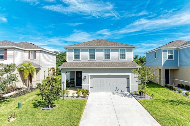 view of front property featuring a garage and a front yard