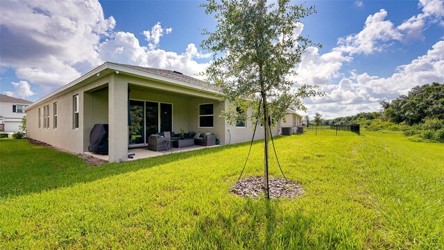 exterior space with a lawn, a patio area, and an outdoor living space