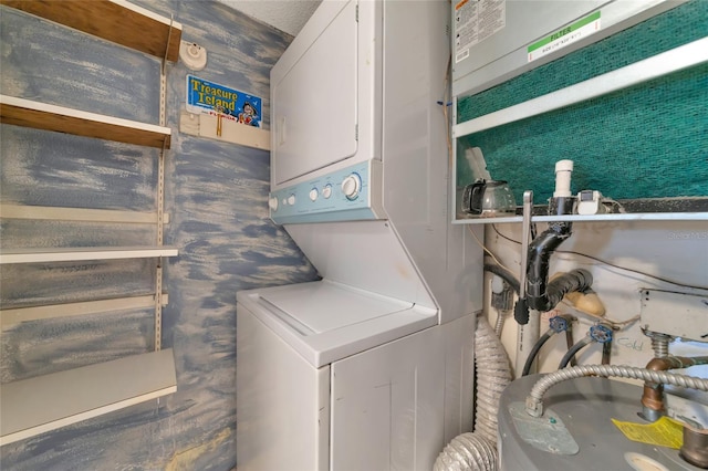 washroom featuring stacked washing maching and dryer and water heater