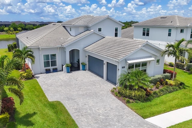 view of front of home with a front yard and a garage