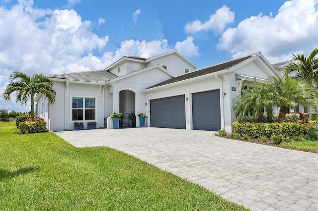 view of front facade with a garage and a front lawn