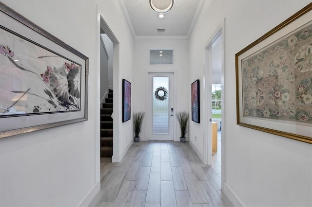 entryway featuring crown molding