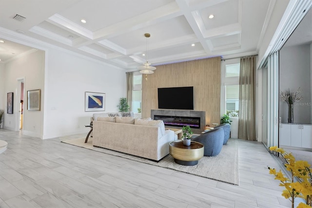 living room featuring a fireplace, coffered ceiling, and a wealth of natural light